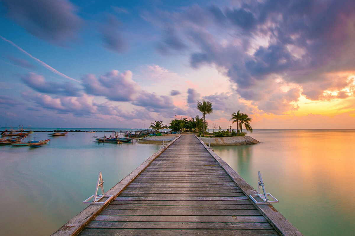 Wooden Pier and Golden Sunset over the Gulf of Thailand