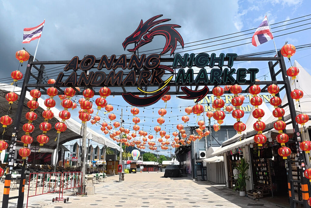 Decorative red lantern archway and dragon sign at the entrance to Ao Nang Landmark Night Market, Krabi