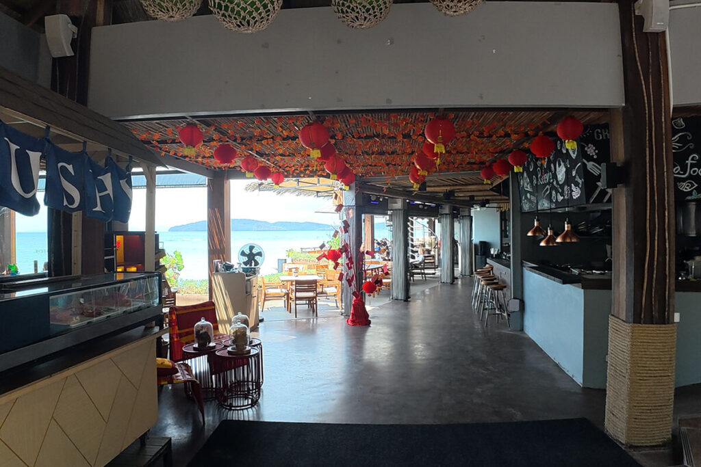 Open-air restaurant and sushi bar interior looking out towards the Andaman Sea at Reeve Beach Club